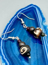Load image into Gallery viewer, Mismatched round bone beads create an adaptable look when paired with neutral colors and wavy patterns, enabling wearers to tailor their ensembles in whatever way they desire. Measurements: 1 1/2 ” in length