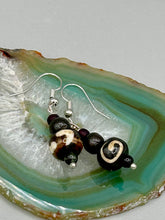 Load image into Gallery viewer, Mismatched round bone beads create an adaptable look when paired with neutral colors and wavy patterns, enabling wearers to tailor their ensembles in whatever way they desire. Measurements: 1 1/2 ” in length