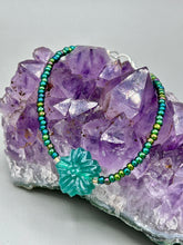 Load image into Gallery viewer, This blue-green pressed glass floral beaded bracelet is a nature-inspired accessory that adds a hint of summer to any look. Crafted with intricate green-blue pressed glass beads and metal wire, the bracelet has an iridescent shimmer finish and a lobster claw clasp for secure wear. Perfect for day-to-night looks.  Measurements:  Bracelet: 8 1/2" in length