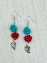 Load image into Gallery viewer, This alluring set of earrings captures the vibrant, enchanting beauty of the desert, featuring blue turquoise and bright red accents, highly detailed quartize rose beads and intricate silver plated leaf, providing fun movement. Perfect for those who love the Southwestern feel, Dia De Los Muertos, they can be dressed up or down, giving your fashion a unique touch. Measurements: 2” in length
