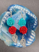 Load image into Gallery viewer, This alluring set of earrings captures the vibrant, enchanting beauty of the desert, featuring blue turquoise and bright red accents, highly detailed quartize rose beads and intricate silver plated leaf, providing fun movement. Perfect for those who love the Southwestern feel, Dia De Los Muertos, they can be dressed up or down, giving your fashion a unique touch. Measurements: 2” in length