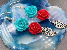 Load image into Gallery viewer, This alluring set of earrings captures the vibrant, enchanting beauty of the desert, featuring blue turquoise and bright red accents, highly detailed quartize rose beads and intricate silver plated leaf, providing fun movement. Perfect for those who love the Southwestern feel, Dia De Los Muertos, they can be dressed up or down, giving your fashion a unique touch. Measurements: 2” in length
