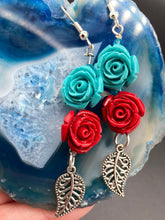 Load image into Gallery viewer, This alluring set of earrings captures the vibrant, enchanting beauty of the desert, featuring blue turquoise and bright red accents, highly detailed quartize rose beads and intricate silver plated leaf, providing fun movement. Perfect for those who love the Southwestern feel, Dia De Los Muertos, they can be dressed up or down, giving your fashion a unique touch. Measurements: 2” in length
