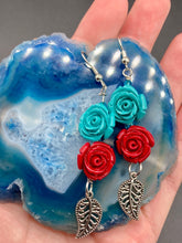 Load image into Gallery viewer, This alluring set of earrings captures the vibrant, enchanting beauty of the desert, featuring blue turquoise and bright red accents, highly detailed quartize rose beads and intricate silver plated leaf, providing fun movement. Perfect for those who love the Southwestern feel, Dia De Los Muertos, they can be dressed up or down, giving your fashion a unique touch. Measurements: 2” in length