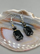 Load image into Gallery viewer, Elegantly crafted from black rectangular and circular glass beads, these dainty earrings offer a versatile style that can effortlessly elevate any ensemble.  Measurements: 1 3/8” in length