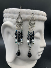 Load image into Gallery viewer, This stylish three-strand black and silver glass beaded earring design presents a beautiful dancing effect, boasting a large black teardrop glass bead. A versatile accessory, it suits a variety of ensembles from cocktail chic to wedding fineries, and its minimalist aesthetic lends a modern charm.  Measurements: 3 3/4” in length