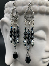 Load image into Gallery viewer, This stylish three-strand black and silver glass beaded earring design presents a beautiful dancing effect, boasting a large black teardrop glass bead. A versatile accessory, it suits a variety of ensembles from cocktail chic to wedding fineries, and its minimalist aesthetic lends a modern charm.  Measurements: 3 3/4” in length