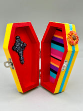 Load image into Gallery viewer, Coffin keepsake box represents the eternal love for a special kitty cat in your life. Cat silhouette sitting admiring the moon and stars. Day Of The Dead art was created for the cat lovers who adore their sweet kitty. Coffin-shaped box features a bright and vibrant canary yellow exterior, with an adoring blue crescent moon and star. Complemented with a shimmery blue ribbon and flower, the inside is painted in a bright red hue with black floral cross and detailing a traditional Mexican-themed fabric.