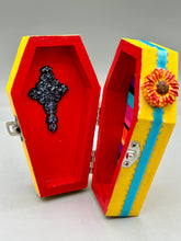 Load image into Gallery viewer, Coffin keepsake box represents the eternal love for a special kitty cat in your life. Cat silhouette sitting admiring the moon and stars. Day Of The Dead art was created for the cat lovers who adore their sweet kitty. Coffin-shaped box features a bright and vibrant canary yellow exterior, with an adoring blue crescent moon and star. Complemented with a shimmery blue ribbon and flower, the inside is painted in a bright red hue with black floral cross and detailing a traditional Mexican-themed fabric.