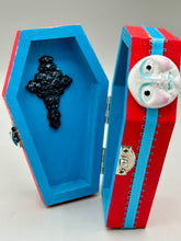 Load image into Gallery viewer, Coffin keepsake box represents the eternal love for a special kitty cat in your life. Cat silhouette sitting admiring the moon and stars. Day Of The Dead art was created for the cat lovers who adore their sweet kitty. Coffin-shaped box features a bright and vibrant red exterior, with an adoring yellow crescent moon and star. Complemented with a shimmery blue ribbon and smiling moon, the inside is painted in a bright bluer hue with black floral cross and detailing a traditional Mexican-themed fabric.