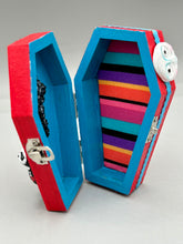 Load image into Gallery viewer, Coffin keepsake box represents the eternal love for a special kitty cat in your life. Cat silhouette sitting admiring the moon and stars. Day Of The Dead art was created for the cat lovers who adore their sweet kitty. Coffin-shaped box features a bright and vibrant red exterior, with an adoring yellow crescent moon and star. Complemented with a shimmery blue ribbon and smiling moon, the inside is painted in a bright bluer hue with black floral cross and detailing a traditional Mexican-themed fabric.