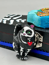 Load image into Gallery viewer, This hand-crafted art magnet featuring a skeleton cat is the ideal home decor for cat lovers, Halloween or Day Of The Dead enthusiasts. Perfect for adorning fridges, lockers, cubicles, and toolboxes.   I wanted to create an art piece that represented the eternal love for a special kitty cat in your life. Add a little touch of Mexican art to your home or office. This Day Of The Dead art was created for the cat lovers who adore their sweet kitty. H 2” x W 1/2” x D 3/8”