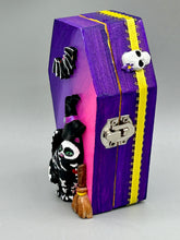 Load image into Gallery viewer, Coffin shaped box features a Day of the Dead kitty cat wearing a cute witchy hat while standing next to her witchy broom and a flying bat friend. The inside of the coffin is adorned with a witchy crescent moon, Jack-O-Lantern and a cute bat. This captivating coffin box makes an eye-catching, bewitching and whimsical Halloween-themed art piece that adds a one-of-a-kind Halloween touch to any home or office. L: 4 7/8"; W: 3"; H: 1 1/2"