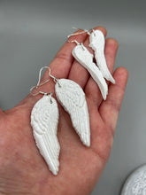 Load image into Gallery viewer, Shimmery white polymer clay earrings in the shape of angel wings are perfect for a subtle yet elegant look.