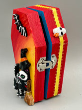 Load image into Gallery viewer, Coffin shaped box features a Day of the Dead kitty cat wearing a cute witchy hat while standing next to her witchy broom and her flying bat friend. The inside of the coffin is adorned with a witchy crescent moon, Jack-O-Lantern and a cute bat. This captivating coffin box makes an eye-catching, bewitching and whimsical Halloween-themed art piece that adds a one-of-a-kind Halloween touch to any home or office.