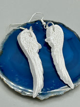 Load image into Gallery viewer, Shimmery white polymer clay earrings in the shape of angel wings are perfect for a subtle yet elegant look.