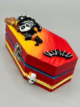 Load image into Gallery viewer, Coffin shaped box features a Day of the Dead kitty cat wearing a cute witchy hat while standing next to her witchy broom and her flying bat friend. The inside of the coffin is adorned with a witchy crescent moon, Jack-O-Lantern and a cute bat. This captivating coffin box makes an eye-catching, bewitching and whimsical Halloween-themed art piece that adds a one-of-a-kind Halloween touch to any home or office.