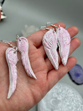 Load image into Gallery viewer, Light pastel pink polymer clay earrings in the shape of angel wings are perfect for a subtle yet elegant look. These earrings are designed to face forward when worn for a more flattering silhouette.