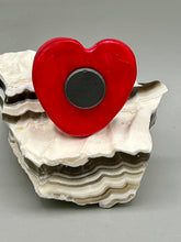 Load image into Gallery viewer, This hand-crafted art magnet is featuring a skeleton kitty cat, is the ideal home decor for cat lovers, Halloween, or Day Of The Dead enthusiasts. Perfect for adorning Day of the Dead ofrenda, a witchy altar, goth, or spooky Halloween home decor. Purrfectly cute and spooky Halloween magnet art to add to your fridge, locker, cubicle or toolbox. This hand-crafted heart-shaped magnet features a figurine of a black cat with ombre pink and red heart. 