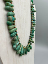 Load image into Gallery viewer, This striking Extra Large Turquoise Stone Beaded Necklace With Brass Finish Metal Beads instantly adds a touch of luxury to any outfit. Beautifully crafted with an alluring blend of extra large turquoise stone beads and brass finish metal beads, this distinctive necklace invokes an elegant cascade of vibrant color.    Measurements:    Necklace is 21 1/2 " in length adjustable to 23"