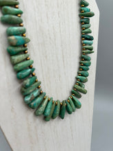 Load image into Gallery viewer, This striking Extra Large Turquoise Stone Beaded Necklace With Brass Finish Metal Beads instantly adds a touch of luxury to any outfit. Beautifully crafted with an alluring blend of extra large turquoise stone beads and brass finish metal beads, this distinctive necklace invokes an elegant cascade of vibrant color.    Measurements:    Necklace is 21 1/2 " in length adjustable to 23"