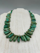 Load image into Gallery viewer, This striking Extra Large Turquoise Stone Beaded Necklace With Brass Finish Metal Beads instantly adds a touch of luxury to any outfit. Beautifully crafted with an alluring blend of extra large turquoise stone beads and brass finish metal beads, this distinctive necklace invokes an elegant cascade of vibrant color.    Measurements:    Necklace is 21 1/2 " in length adjustable to 23"