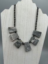 Load image into Gallery viewer, This rustic necklace features an eye-catching large trapezoid-shaped Picasso jasper and black agate combo set in a unique and chic design. Handcrafted from genuine stones, this necklace is perfect for any bohemian look. Measurements: Necklace is 19 1/2"