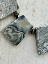 Load image into Gallery viewer, This rustic necklace features an eye-catching large trapezoid-shaped Picasso jasper and black agate combo set in a unique and chic design. Handcrafted from genuine stones, this necklace is perfect for any bohemian look. Measurements: Necklace is 19 1/2"