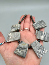 Load image into Gallery viewer, This rustic necklace features an eye-catching large trapezoid-shaped Picasso jasper and black agate combo set in a unique and chic design. Handcrafted from genuine stones, this necklace is perfect for any bohemian look. Measurements: Necklace is 19 1/2"