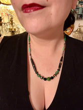 Load image into Gallery viewer, This exquisite necklace features natural ruby zoisite, black obsidian, turquoise magnesite, bone, glass and metal beads, offering a variety of sizes, shapes, textures, and colors. Measurements: Necklace - 20" in length