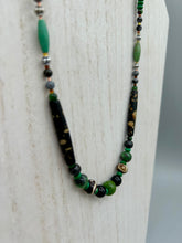 Load image into Gallery viewer, This exquisite necklace features natural ruby zoisite, black obsidian, turquoise magnesite, bone, glass and metal beads, offering a variety of sizes, shapes, textures, and colors. Measurements: Necklace - 20" in length