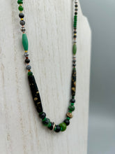Load image into Gallery viewer, This exquisite necklace features natural ruby zoisite, black obsidian, turquoise magnesite, bone, glass and metal beads, offering a variety of sizes, shapes, textures, and colors. Measurements: Necklace - 20" in length