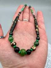Load image into Gallery viewer, This exquisite necklace features natural ruby zoisite, black obsidian, turquoise magnesite, bone, glass and metal beads, offering a variety of sizes, shapes, textures, and colors. Measurements: Necklace - 20" in length