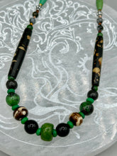 Load image into Gallery viewer, This exquisite necklace features natural ruby zoisite, black obsidian, turquoise magnesite, bone, glass and metal beads, offering a variety of sizes, shapes, textures, and colors. Measurements: Necklace - 20" in length