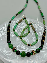 Load image into Gallery viewer, These stylish fish hook style earrings feature intricate beadwork crafted with forest green magnesite and ruby zoisite stones. Measurements: 2 3/4" length