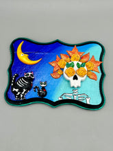 Load image into Gallery viewer, La Catrina y Gatita wall art is the purrfect hanging Day of the Dead art piece to add to your ofrenda. A tribute to an unbreakable bond and eternal love between cats and their guardians. Featuring a vibrant and intricate detail catrina and her floral crown accompanied by her beloved kitty cat. This Day of the Dead-inspired artwork adds a little touch of Mexican art to your home or office. A unique handcrafted gift for any cat lover. Measurements: H 5" x W 7” x D 1 1/2"