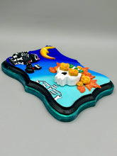 Load image into Gallery viewer, La Catrina y Gatita wall art is the purrfect hanging Day of the Dead art piece to add to your ofrenda. A tribute to an unbreakable bond and eternal love between cats and their guardians. Featuring a vibrant and intricate detail catrina and her floral crown accompanied by her beloved kitty cat. This Day of the Dead-inspired artwork adds a little touch of Mexican art to your home or office. A unique handcrafted gift for any cat lover. Measurements: H 5" x W 7” x D 1 1/2"