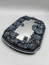 Load image into Gallery viewer, Make a bold statement with this handcrafted Goth Floral Decorative Mirror Wall Art Decor. The wood frame is complimented with highly detailed flowers, leaf and vine motifs, enhanced with shimmery metallic highlights for added texture and depth. Each intricate detail is carefully sculpted to create a unique and beautiful piece that's sure to make a statement. H 6 3/4" x W 9 1/2” x D 1"