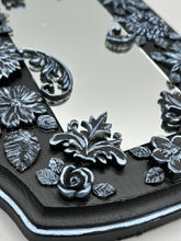 Load image into Gallery viewer, Make a bold statement with this handcrafted Goth Floral Decorative Mirror Wall Art Decor. The wood frame is complimented with highly detailed flowers, leaf and vine motifs, enhanced with shimmery metallic highlights for added texture and depth. Each intricate detail is carefully sculpted to create a unique and beautiful piece that's sure to make a statement. H 6 3/4" x W 9 1/2” x D 1"
