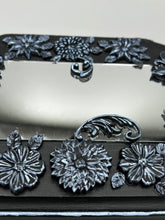 Load image into Gallery viewer, Make a bold statement with this handcrafted Goth Floral Decorative Mirror Wall Art Decor. The wood frame is complimented with highly detailed flowers, leaf and vine motifs, enhanced with shimmery metallic highlights for added texture and depth. Each intricate detail is carefully sculpted to create a unique and beautiful piece that's sure to make a statement. H 6 3/4" x W 9 1/2” x D 1"