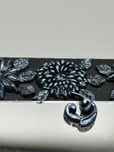 Load image into Gallery viewer, Make a bold statement with this handcrafted Goth Floral Decorative Mirror Wall Art Decor. The wood frame is complimented with highly detailed flowers, leaf and vine motifs, enhanced with shimmery metallic highlights for added texture and depth. Each intricate detail is carefully sculpted to create a unique and beautiful piece that's sure to make a statement. H 6 3/4" x W 9 1/2” x D 1"