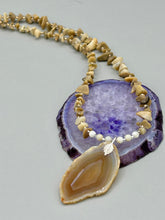Load image into Gallery viewer, This Light Brown Banded Agate Geode Sliced Stone Chip Necklace is a luxurious addition to any jewelry collection. It features natural, light brown agate banded geode in a luxurious earth-tone. Suspended on a unique strand of natural bamboo chips and gold and clear beaded necklace. The combination of neutral colors and nature inspired design makes them the perfect accessory for any outfit. Measurements: Necklace is 18” in length - pendant is 2” Height
