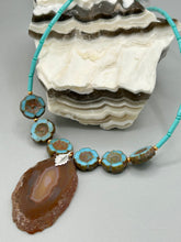 Load image into Gallery viewer, This exquisite Natural Dark Brown Agate Geode Sliced Stone Chip Necklace adds a unique touch of luxury to any look. Its banded geode and hibiscus flower glass beads offer a sophisticated bohemian style, and the natural gemstones are sure to make a statement. Add it to any outfit for a stylish and timeless touch. Measurements: Necklace is 18” in length - pendant is 1 3/4” Height Amber Stone Chip Earrings: 2" in length