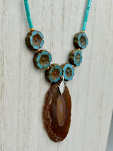 Load image into Gallery viewer, This exquisite Natural Dark Brown Agate Geode Sliced Stone Chip Necklace adds a unique touch of luxury to any look. Its banded geode and hibiscus flower glass beads offer a sophisticated bohemian style, and the natural gemstones are sure to make a statement. Add it to any outfit for a stylish and timeless touch. Measurements: Necklace is 18” in length - pendant is 1 3/4” Height Amber Stone Chip Earrings: 2" in length