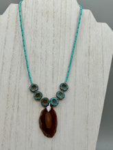Load image into Gallery viewer, This exquisite Natural Dark Brown Agate Geode Sliced Stone Chip Necklace adds a unique touch of luxury to any look. Its banded geode and hibiscus flower glass beads offer a sophisticated bohemian style, and the natural gemstones are sure to make a statement. Add it to any outfit for a stylish and timeless touch. Measurements: Necklace is 18” in length - pendant is 1 3/4” Height Amber Stone Chip Earrings: 2" in length