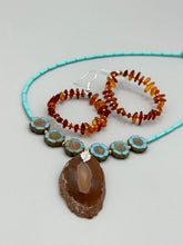 Load image into Gallery viewer, These hoop earrings feature natural amber stone chips and gold glass beads for an elegant, nature-inspired look. Measurements: 2" length and 2” in width