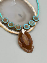 Load image into Gallery viewer, This exquisite Natural Dark Brown Agate Geode Sliced Stone Chip Necklace adds a unique touch of luxury to any look. Its banded geode and hibiscus flower glass beads offer a sophisticated bohemian style, and the natural gemstones are sure to make a statement. Add it to any outfit for a stylish and timeless touch. Measurements: Necklace is 18” in length - pendant is 1 3/4” Height Amber Stone Chip Earrings: 2" in length