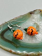 Load image into Gallery viewer, These super tiny and cute Peruvian Ceramic Jack-o-Lantern pumpkin halloween bead earrings are just perfect for fall and halloween. If halloween is not a season, rather a lifestyle, then these are perfect for every day outfits! Measurements: 7/8” in length, pumpkin beads 11mm