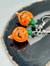 Load image into Gallery viewer, These super tiny and cute Peruvian Ceramic Jack-o-Lantern pumpkin halloween bead earrings are just perfect for fall and halloween. If halloween is not a season, rather a lifestyle, then these are perfect for every day outfits! Measurements: 7/8” in length, pumpkin beads 11mm