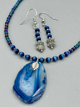 Load image into Gallery viewer, Chic and fun silver-plated owl charm earrings featuring delicate dark blue cats eye beads. Measurements: 1 3/16” in length